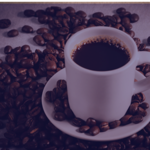 Coffee Cup sitting on coffee beans