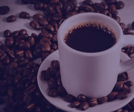 Coffee Cup sitting on coffee beans